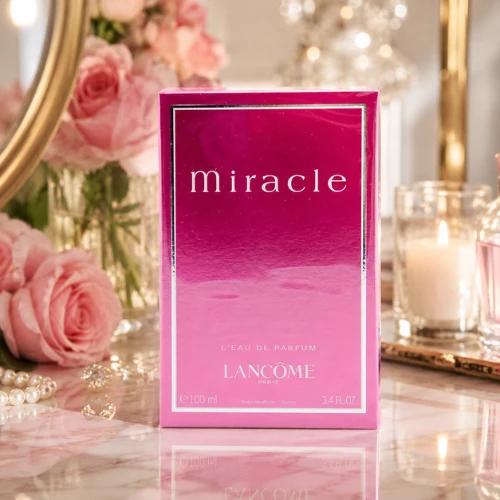 Lancôme Miracle Eau de Parfum pink box on a marble surface with roses