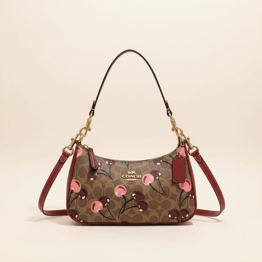Coach signature canvas shoulder bag with cherry print and red accents